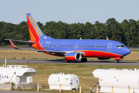 N643SW @ ORF - Southwest Airlines N643SW (FLT SWA2563) taxiing to the gate via Taxiway Charlie after arrival from Baltimore/Washington Int'l (KBWI). In the foreground are three liquid storage tanks that contain Propylene Glycol de-icing fluid. - by Dean Heald