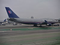 N187UA @ KLAX - United Airlines Boeing 747-422, N187UA getting a tow to the United hangar KLAX. - by Mark Kalfas