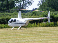 G-CGNE @ X2FF - Robinson R44 being used for ferrying race fans to Silverstone for the British Grand Prix from this temporary heliport a few miles east of Bicester - by Chris Hall