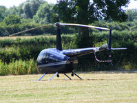 G-BZXY @ X2FF - Robinson R44 being used for ferrying race fans to Silverstone for the British Grand Prix from this temporary heliport a few miles east of Bicester - by Chris Hall