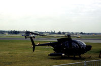 N58235 @ FAB - Hughes 500MD Defender on the flight-line at the 1978 SBAC Farnborough Airshow. - by Peter Nicholson