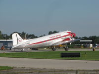 N143D @ KOSH - Douglas 75 years decal on tail.Caught in bright sun shine - by steveowen