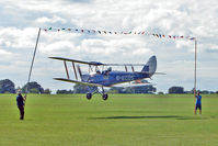G-ECDS @ EGBK - 1943 DE HAVILLAND AIRCRAFT CO LTD DH82A TIGER MOTH C/N 86347  attempts to 'limbo' the washing line of bunting at the 2010 Sywell Airshow - by Terry Fletcher