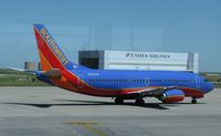 N327SW @ KDEN - Sorry for the window glare. Southwest Airlines Boeing 737-300 taxiing to the runway. - by Kreg Anderson