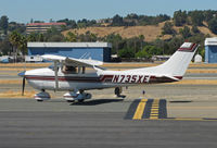 N735XE @ KCCR - Locally-based 1977 Cessna 182Q on way to RWY1R with Concord Jet hangars in background - by Steve Nation