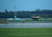 OK-MMI @ LOWW - Eurocopter EC-120 followingthe followme-car along taxiway like a plane - by Thomas Ranner