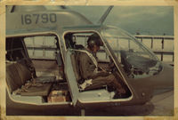 68-16790 - Taken in a revetment at  Sanford Army Airfield, Long Bien, Viet Nam. July of 1970.  I'm filling out the log book after concluding all the flights for the day.  Grenades & M-60 machine gun in the back. - by Bookie
