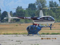 C-FAMZ @ CYKA - ...R-44 hover-taxiing past a long-line equipped MD-500  that is set up for fire-fighting - by Blindawg