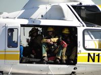 N110LA @ POC - Fire fighters on board and recieving instructions from helicopter crew member - by Helicopterfriend