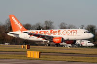 G-EZBX @ EGCC - Easyjet A319 touching down on RW05L - by Chris Hall