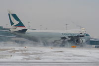 B-HUH @ EGCC - Cathy Pacific B747 kicking up the snow with full reverse thrust while landing on RW05L - by Chris Hall