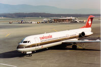 HB-IVB @ GVA - Fokker F100 of Swissair at the terminal at Geneva in March 1993. - by Peter Nicholson
