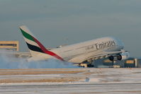A6-EDG @ EGCC - Emirates A380 kicking up the snow as it departs from RW05L - by Chris Hall
