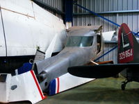 G-BSWH @ EGBD - stored in the corner of the main hangar - by Chris Hall