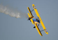 N49739 @ KOSH - AIRVENTURE 2010, note the raw fuel from the exhaust burning along the side of the aircraft.