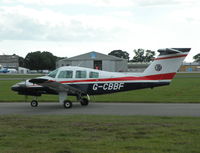 G-CBBF @ EGHH - Duchess taxying past the Flying Club - by BIKE PILOT