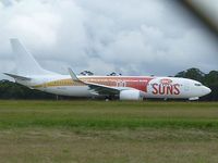 VH-VUZ @ YMML - Virgin Blue logojet for the Gold Coast Suns, a new franchise in the Australian Football League, at the holding point for runway 16 at Melbourne (Tullamarine). Taken through the perimeter fence. - by red750