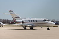 N860QS @ KDPA - Photographed through a chain-link fence.