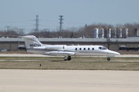 N947GS @ KDPA - Taxiing to Runway 2L.  Photographed through a chain-link fence.