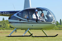 G-BZGO @ EGCB - 2000 Robinson R44 Astro, c/n: 0757 giving helicopter joy rides at Open Day - this lad looked as if he really enjoyed himself - by Terry Fletcher