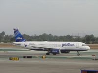 N588JB @ LAX - Hopelessly devoted to blue is taxiing to runway 24L for take off - by Helicopterfriend