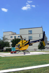 N433P @ TE80 - On the pad at Medical Center of Arlington (with air conditioner attached...it's only 105 degrees out there)