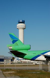 N450ML @ OPF - Miami Leasing Inc., McDonnell Douglas DC-10-30F No. N450ML and the Control Tower at Opa Locka Airport, Opa Locka, FL - by scotch-canadian