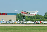 N4616C @ OSH - Cessna T210N, c/n: 21063576 at a crowded 2011 Oshkosh - by Terry Fletcher