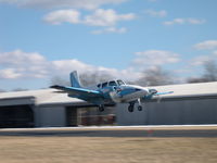 N954T @ 3I3 - Travel Air over the threshold rwy 26.  Formerly N954T, but now known as N210SK