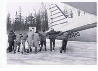 N25669 - 1960  Seward Alaska.  Traveling with the Fairbanks High Basketball team, we went off the runway and had to push the plane back onto the runway. - by Allen Smith
