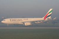 A6-EKT @ EGCC - Emirates A330 taxiing onto 23R in the early morning fog - by Chris Hall
