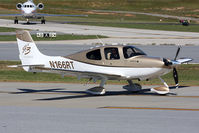 N166RT @ PDK - TBA Aviation LLC's 2007 Cirrus SR22 GTSx G3 Turbo N166RT taxiing to RWY 2L for departure. Little did they know that Taylor Swift was in the Falcon in the background arriving for her make up concert.  - by Dean Heald