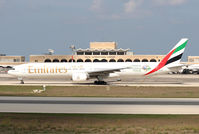 A6-EMV @ LMML - 777 with terminal building