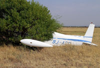 9J-ADO @ FBSK - This has been dumped at Gaborone, Botswana long enough for a tree to grow around it! - by Duncan Kirk