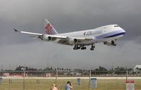 B-18707 @ MIA - China Airlines passing by the famous photo holes, a couple Hungarian spotters that I met standing by the holes - by Daniel Compton