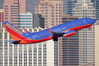 N222WN @ LAS - Southwest Airlines N222WN (FLT SWA297) climbing out from RWY 1R, with a nice backdrop of the NY, NY Hotel and Casino, en route to Phoenix Sky Harbor Int'l (KPHX). - by Dean Heald