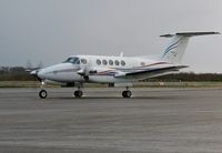 G-MEGN @ EGFH - Super King Air of Cardiff based Dragonfly Aviation Services taxying on a wet apron after landing. - by Roger Winser