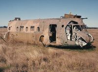 A15-001 - Photograph by Edwin van Opstal with permission. Scanned from a color print. RAAF's first Chinook. Crashed into a dam in 1985. Was recovered and used as a fire training aid at Amberley.