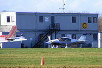 G-CBEZ @ EGBT - resident Robin taxiing past the club house and cafe at Turweston - by Chris Hall