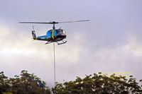 VH-UHE - Hovering, delivering landscaping supplies - by Stephen Bennett