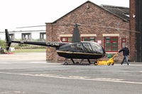 G-CFNF @ EGCB - Robinson R44 Raven II, c/n: 12496 at City of Manchester Airport - by Terry Fletcher