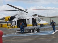 N110LA @ POC - Personnel putting on their lift harnesses for a call out - by Helicopterfriend