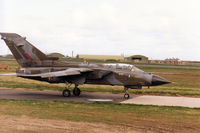 ZA599 @ EGQS - Tornado GR.1 of 12 Squadron taxying to Runway 05 at RAF Lossiemouth in April 1996 and wearing traces of the previous unit markings of the Tri-National Tornado Training Establishment on the fin. - by Peter Nicholson