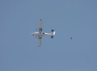 N321CY @ LAL - SOCOM jumper seen flying through the air below the jump plane - by Florida Metal
