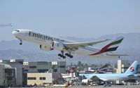 A6-EWE @ KLAX - Departing LAX on 25R - by Todd Royer