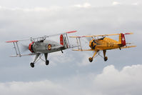 G-AXMT @ EGBR - Doflug Bu-133C Jungmeister with CASA 1-133C Jungmeister G-BVXJ at The Real Aeroplane Company's Summer Madness Fly-In, Breighton Airfield, August 2012. - by Malcolm Clarke