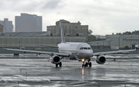 N852UA @ KEWR - A United Airbus A319 taxies in at a very wet Newark International, having weathered severe rainstorms. - by Daniel L. Berek