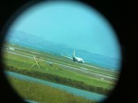 YJ-AV1 @ NZAA - I know you cannot see great detail but thought trying to use my iphone through the binoculars gave an unusal photo. - by magnaman
