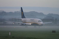 EI-CNZ @ EGHH - Shortly before withdrawal a few days later, caught in the early morning mist. - by Howard J Curtis