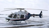 N229AM @ KAXN - Bell 407 of LifeLink III at the fuel pump. - by Kreg Anderson